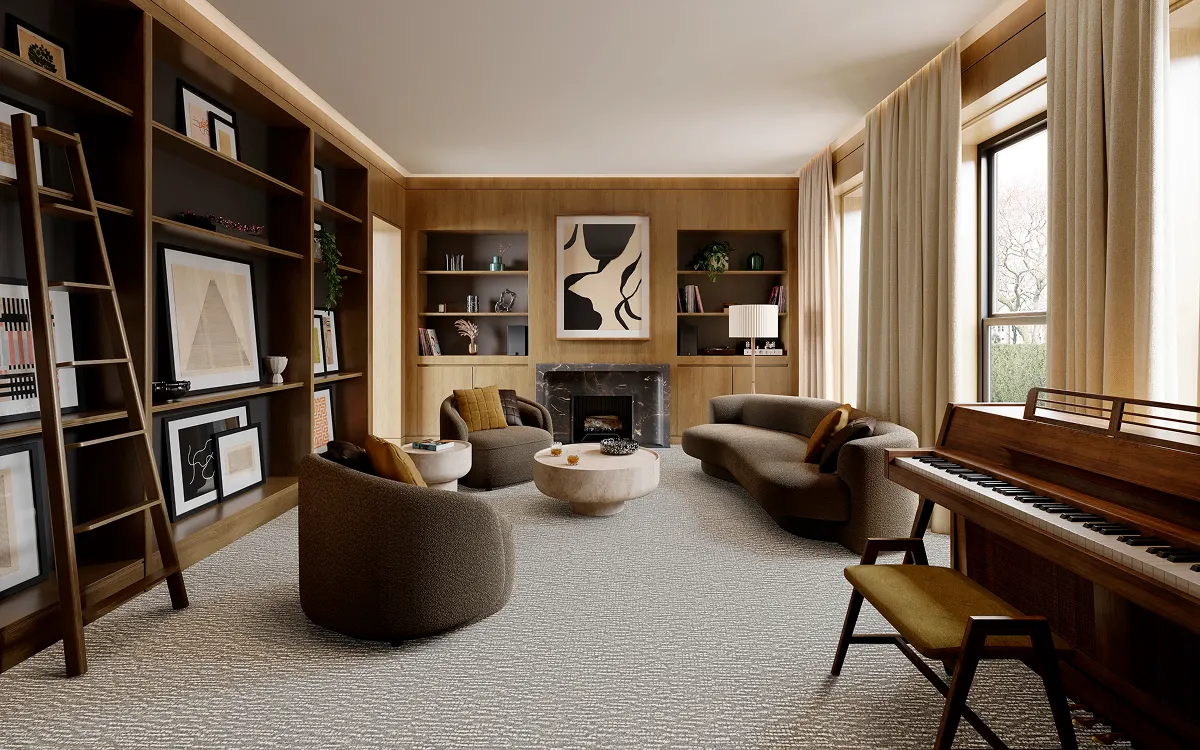 Neutral carpet flooring in an elegant living room with built-in shelving and a piano | Kay Riley Carpet & Flooring
